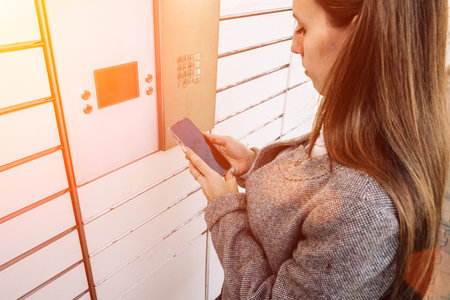 postal terminal. Post delivery automat service and hands with parcel courier box. Mail delivery and post service conceptの写真素材