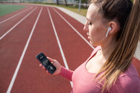 training music. Lifestyle workout exercise woman training. Young beautiful girl doing sports. Sport music and healthy lifestyleの写真素材