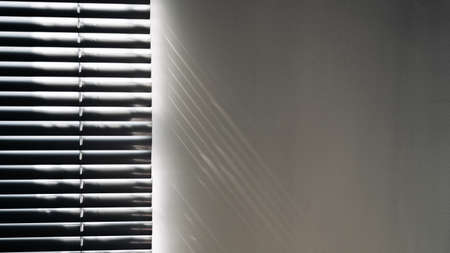 Shadows on wall. Abstract light, black shadow overlay from window on white texture wall. Sunlight architecture background. For product presentation, backdrop and mockup, summer seasonal conceptの写真素材