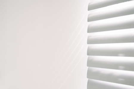 Shadows on wall. Abstract light, black shadow overlay from window on white texture wall. Sunlight architecture background. For product presentation, backdrop and mockup, summer seasonal conceptの写真素材