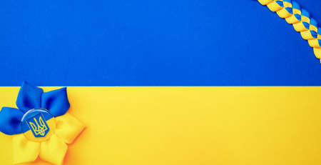 Ukrainian flower trident symbol isolated on yellow blue flag. Yellow and blue banner background, flat lay, copy spaceの写真素材
