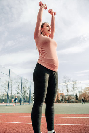 Pregnancy exercise. Pregnant woman training yoga sport exercise. Prenatal healthy fitness active fit...