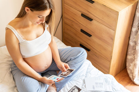 Pregnancy health app. Pregnant woman holding smartphone. Mobile pregnancy online maternity...