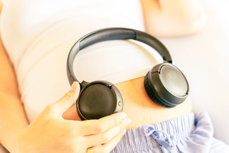 Pregnancy music woman listen. Pregnant woman listening to music. Mother belly listen headphones...