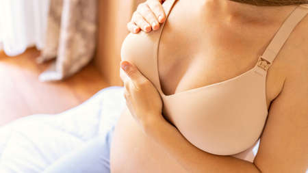 Breast exam cancer pregnancy woman check. Happy young pregnant woman self exam. breast self exam. Health, medicine and beauty conceptの写真素材