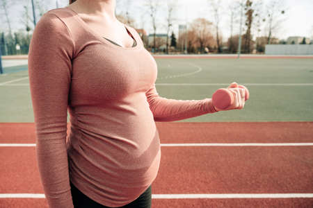 Pregnancy training. Pregnant woman training yoga sport exercise. Prenatal healthy fitness active fit gym outside. Prenatal exercisesの写真素材