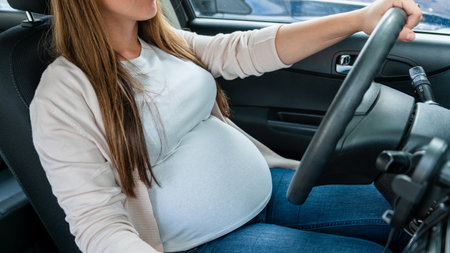 Pregnancy driving car. Young beautiful pregnant woman driving car. Safety pregnancy, mother health care conceptの写真素材