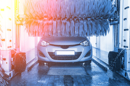 Car wash background automatic carwash. Brush washer clean blue auto car on automatic carwash station. Automated car washing serviceの写真素材