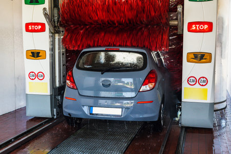 Auto car wash. Auto brush washer clean blue car on automatic carwash station. Automatic car wash...