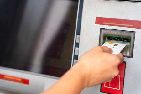 Atm machine money. Hand holding money bank credit card. Withdraw cash from atm. US dollar bill, bank credit cardの写真素材