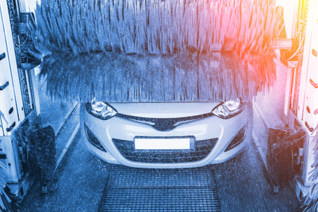 car washing machine. Auto brush washer clean blue car on automatic carwash station. Automated car washing machine backgroundの写真素材