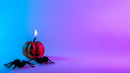 Halloween spider. Scary spooky pumpkin, black night spider on night neon halloween background. Happy Halloween concept. frame. copy spaceの写真素材