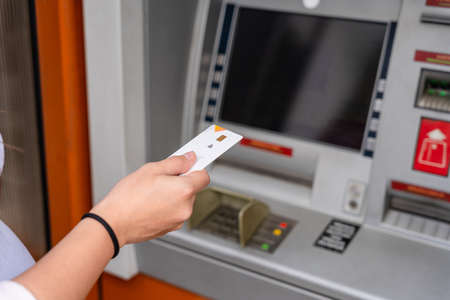 Atm machine screen. Hand holding money bank credit card. Withdraw cash from atm. Money stack, bank credit cardの写真素材