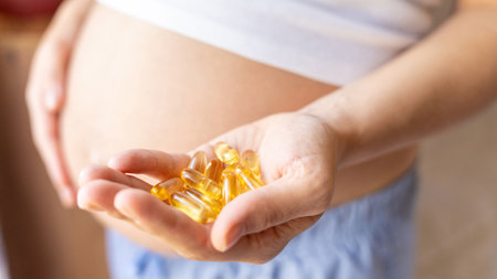 Pregnant vitamins supplement pill. Happy young pregnant woman holding supplement vitamin pill. Therapy, healthcare, motherhood conceptの写真素材