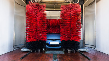 car washing machine. Auto brush washer clean blue car on automatic carwash station. Automated car washing machine backgroundの写真素材