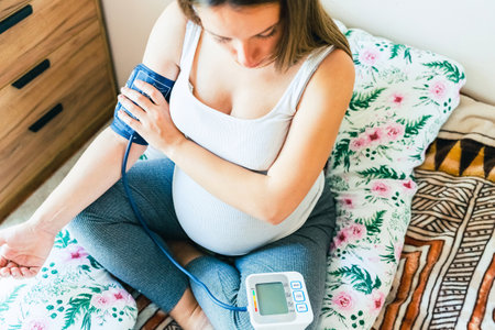 Pregnant blood pressure check hypertension. Pregnancy mother with blood test hypertension check pressure. Concept of pregnancy, maternity, expectation for baby birthの写真素材