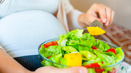 Pregnant salad healthy food. Pregnancy woman eating nutrition diet food salad. Family nutrition, healthy eating conceptの写真素材