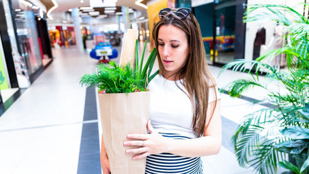 Woman food shopping pregnancy. Pregnant mother with healthy lettuce salad leaves, fresh tomato in market food bag on grocery supermarket background. healthy food backgroundの写真素材