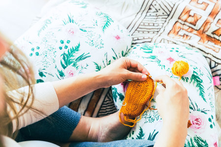 Knitting socks pregnancy woman. Pregnant mother crochet kid cloth. Cute pregnancy woman knit fashion winter baby girl clothes. Cozy knitting womanの写真素材