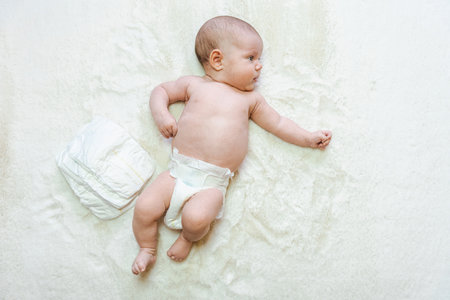 Diaper baby newborn baby banner. child care white background. Happy cute infant baby in nappy. Concept of childhood, motherhood, life, birth. copy spaceの写真素材