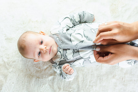 baby lying baby banner. Happy cute baby girl lying on white bed background. Cute little boy lying at bed. Childhood bath conceptの写真素材