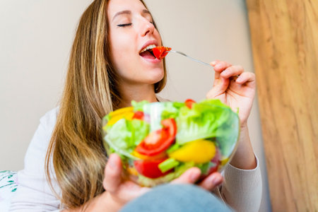 Pregnant woman eating healthy food. Happy pregnancy mother eating nutrition diet salad. healthy breakfast food conceptの写真素材