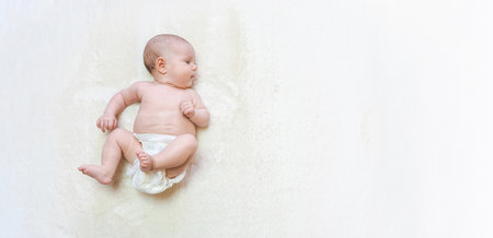 Diaper girl newborn baby banner. child care white background. Happy cute infant baby in nappy. Newborn care, colic, teeth, newborn day regimenの写真素材