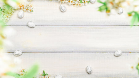 easter spring background. Sakura flower, white happy easter egg on wooden spring background. easter wallpaper. spring holiday conceptの写真素材
