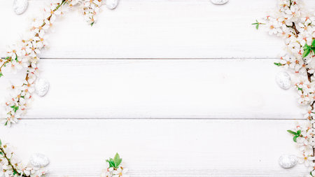 Easter eggs wood. April floral nature, white happy easter eggs on wood spring background. Easter pattern with place for text.の写真素材
