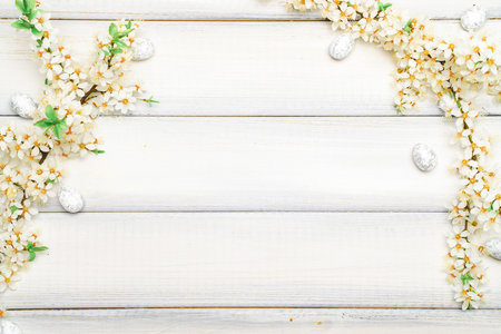 Easter eggs wood. April floral nature, white happy easter eggs on wood spring background. Easter pattern with place for text.の写真素材