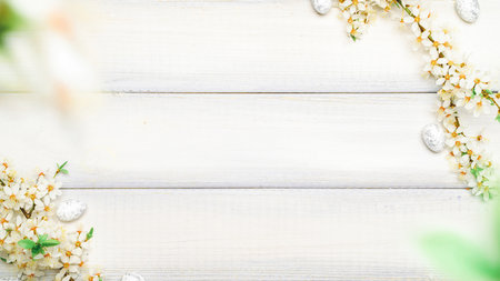 Easter background wood. Sakura blossom flower, white happy easter eggs on wood spring background. Easter design. Top view. Flat lay.の写真素材