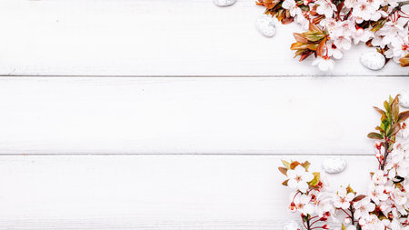 Easter flat. Cherry tree blossom, white happy easter eggs on wood spring background. Springtime concept.の写真素材