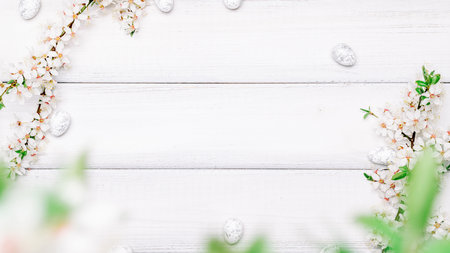 Easter background wood. Sakura blossom flower, white happy easter eggs on wood spring background. Easter design. Top view. Flat lay.の写真素材