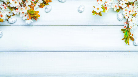 Easter flat. Cherry tree blossom, white happy easter eggs on wood spring background. Springtime concept.の写真素材