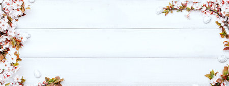 Easter flat banner. Cherry tree blossom, white happy easter eggs on wood spring background. Springtime concept.の写真素材
