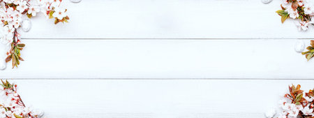 Easter eggs background. May flowers, white happy easter egg on wooden spring background. Easter card banner. Flat lay.の写真素材