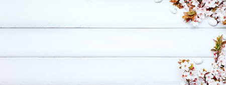 Easter background wood. Sakura blossom flower, white happy easter eggs on wood spring background. Easter design banner. Top view. Flat lay.の写真素材