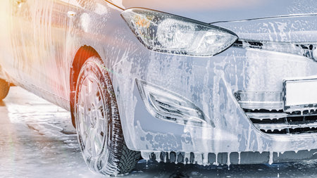 Car wash background. Car washing station foam. Man self service detail splash.の写真素材