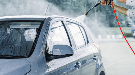 Car washing. Car cleaning soap foam. Spray bubbles pressure wet shine.の写真素材
