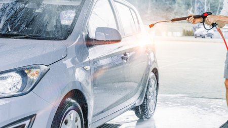 Automobile washing. Car foam bubbles spray. Shiny wet vehicle cleaning.の写真素材