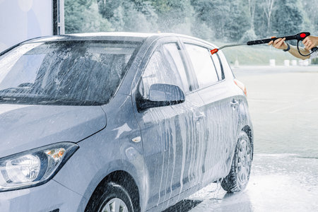 Car wash background. Car washing station foam. Man self service detail splash.の写真素材