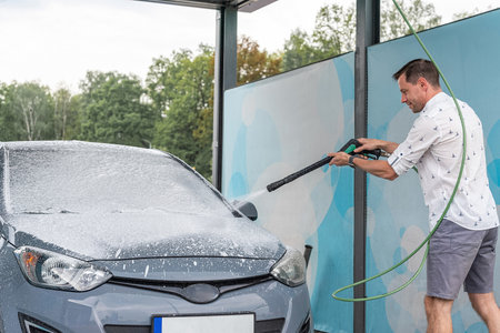Car wash background. Car washing station foam. Man self service detail splash.の写真素材