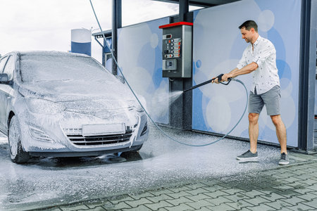 Spray car wash. Foam water bubbles soap. Self service detail pressure wetの写真素材