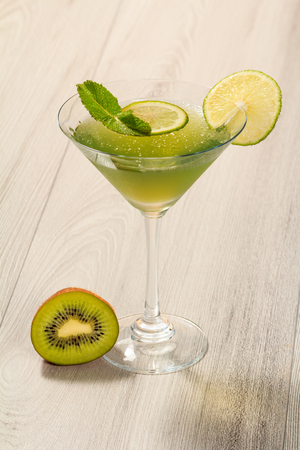 Kiwi jelly with lime pieces in the glass topped mint leavesの写真素材