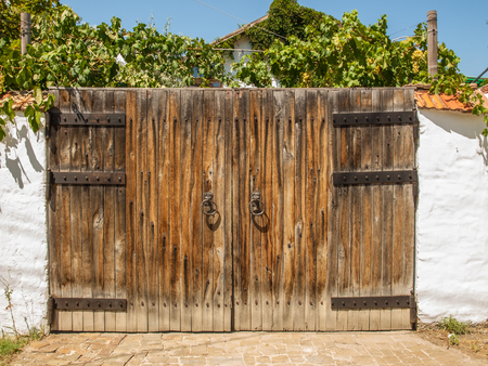 Large closed wooden gate in an old country houseの写真素材