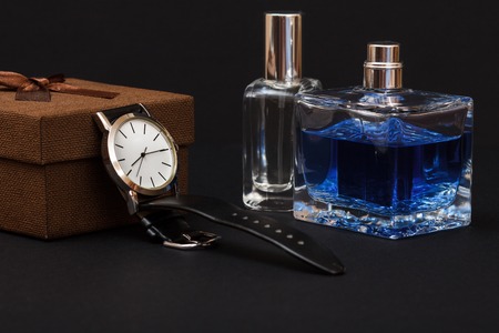 Brown gift box, watch with a black leather strap and perfumes for men on blackの写真素材