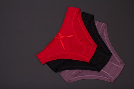 Beautiful red, black and brown cotton panties on blackの写真素材