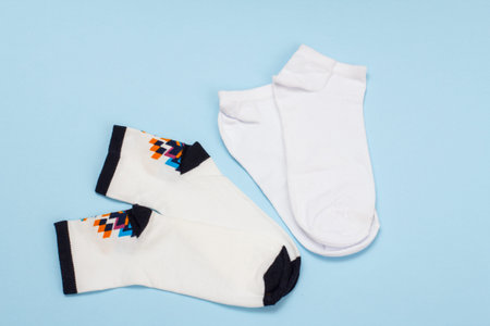 White women socks on a blue background, Top view.