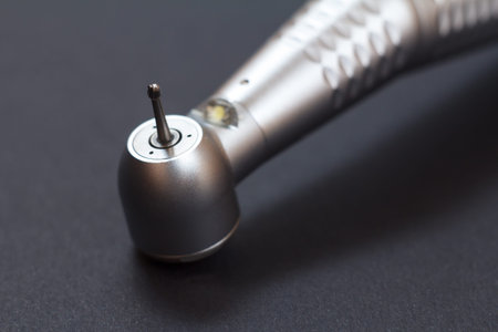 Close-up head of high-speed dental handpiece. Dental instruments for dental treatment on black...