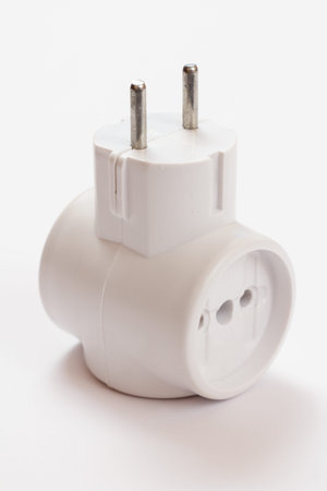 Plastic electrical tee connector with three sockets on a white background.